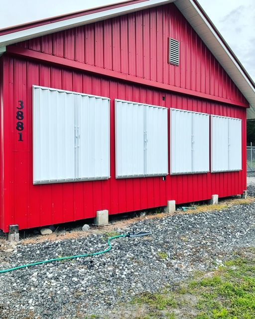 A red building with white shutters on the windows