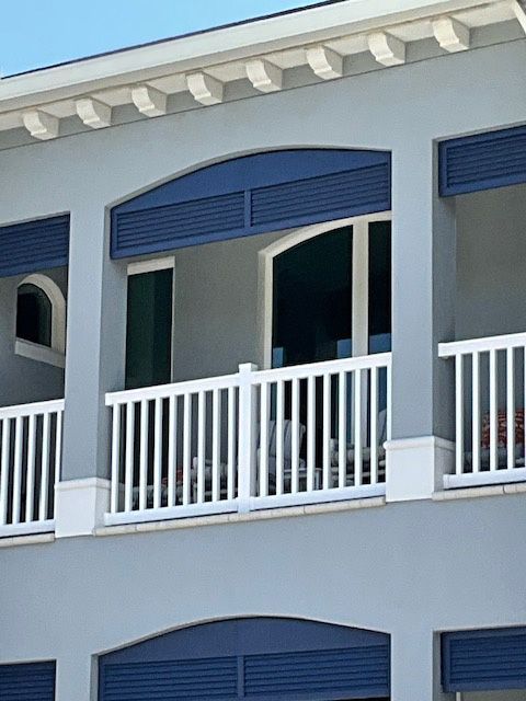 A building with a balcony with a white railing