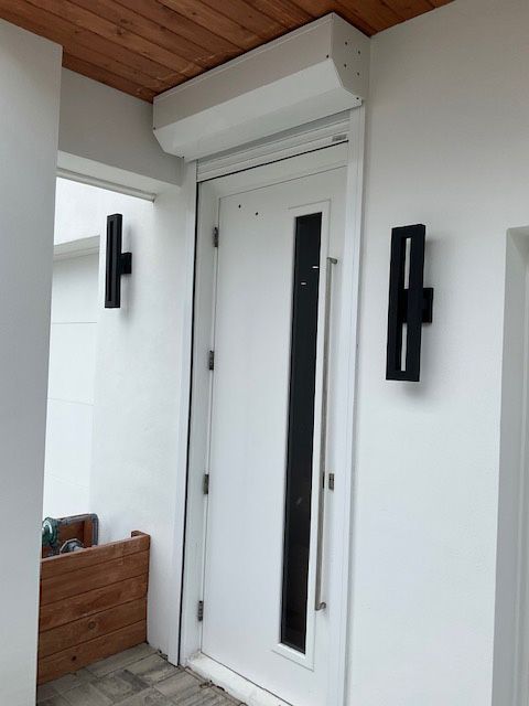 A white door with a black handle and a window