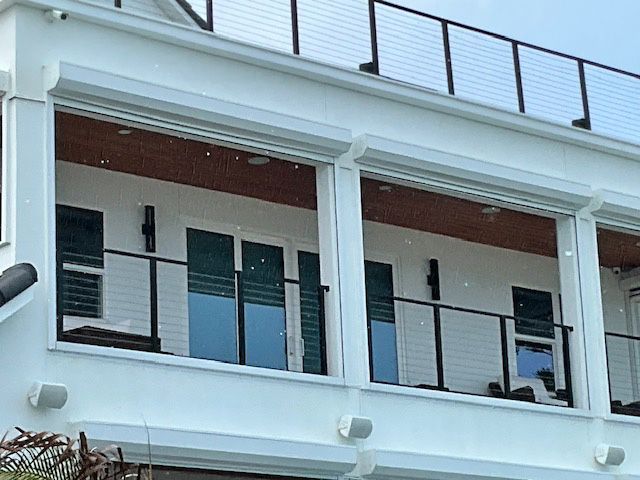 A white building with a balcony and a railing