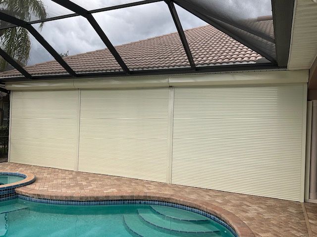 There is a swimming pool in the backyard of a house