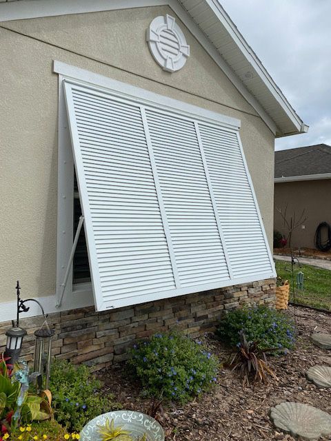 A house with a window with shutters on it