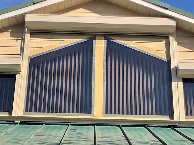 A house with a window with vertical blinds on it