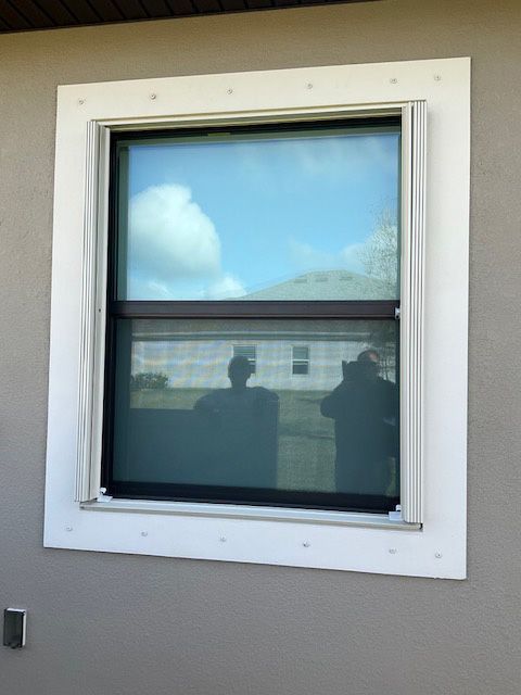 A window with a reflection of two people in it