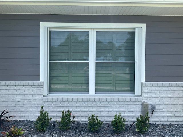 There is a large window on the side of a house