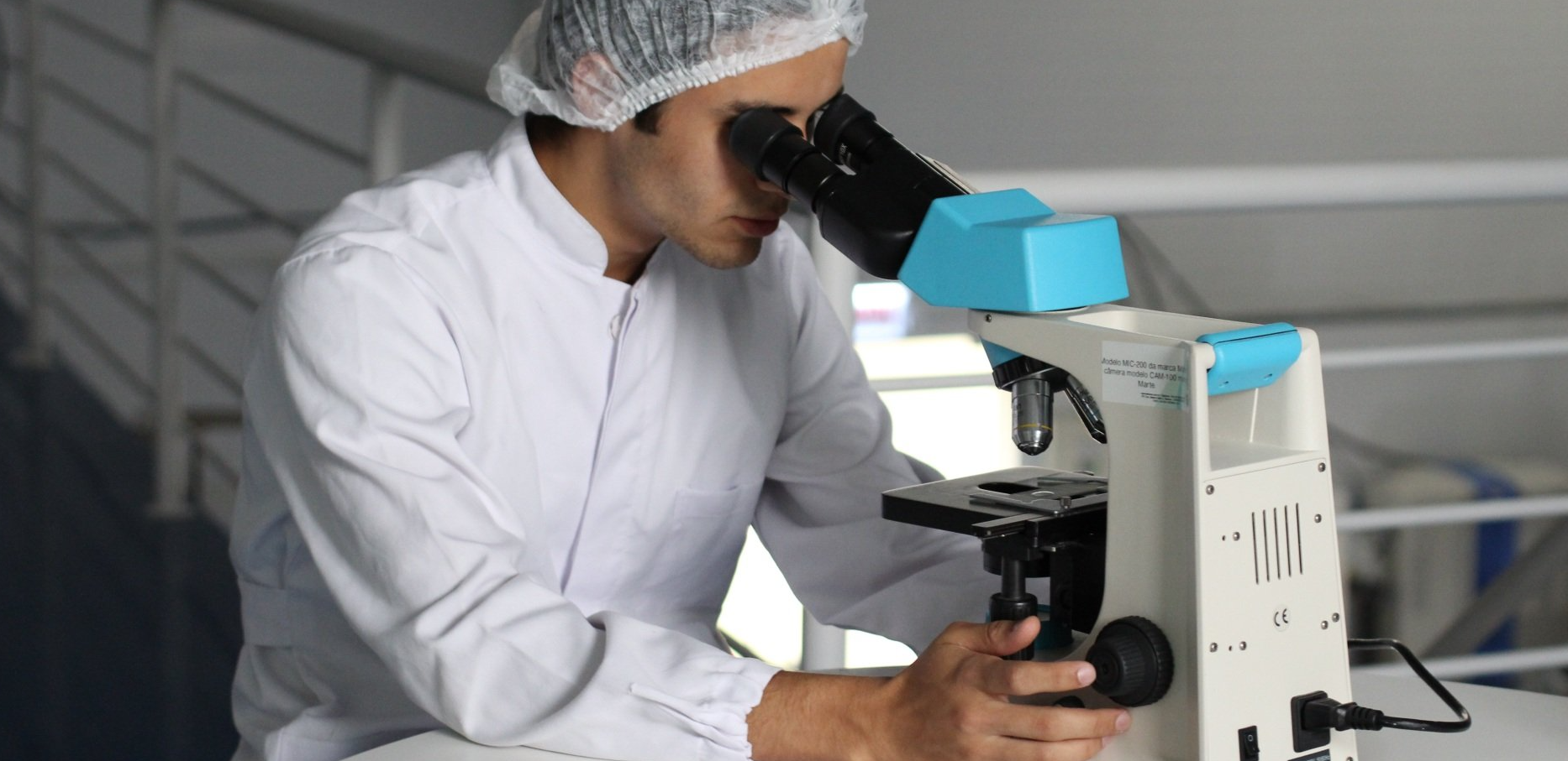 lab worker looking in microscope