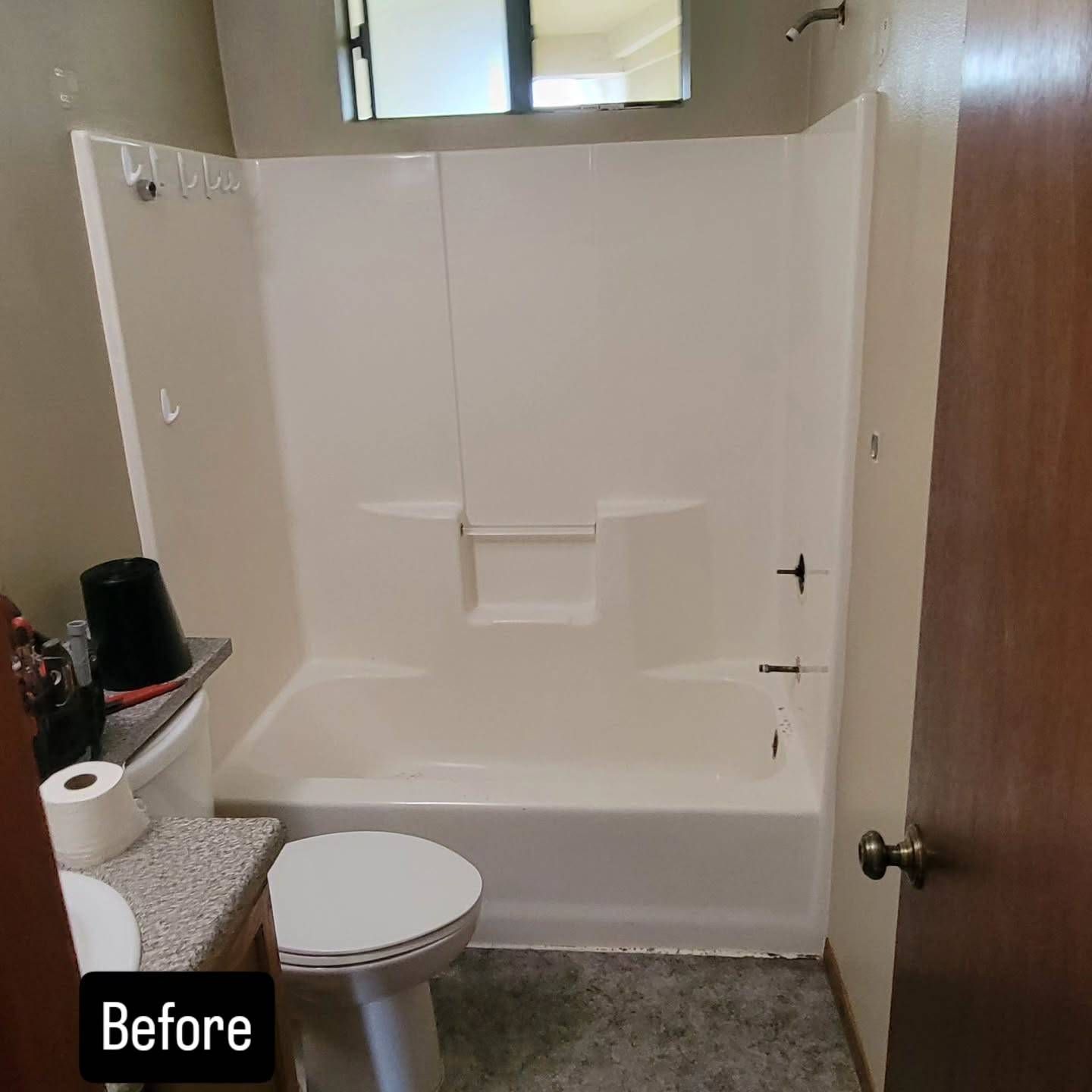 Bathroom with white shower stall, toilet, and sink; 