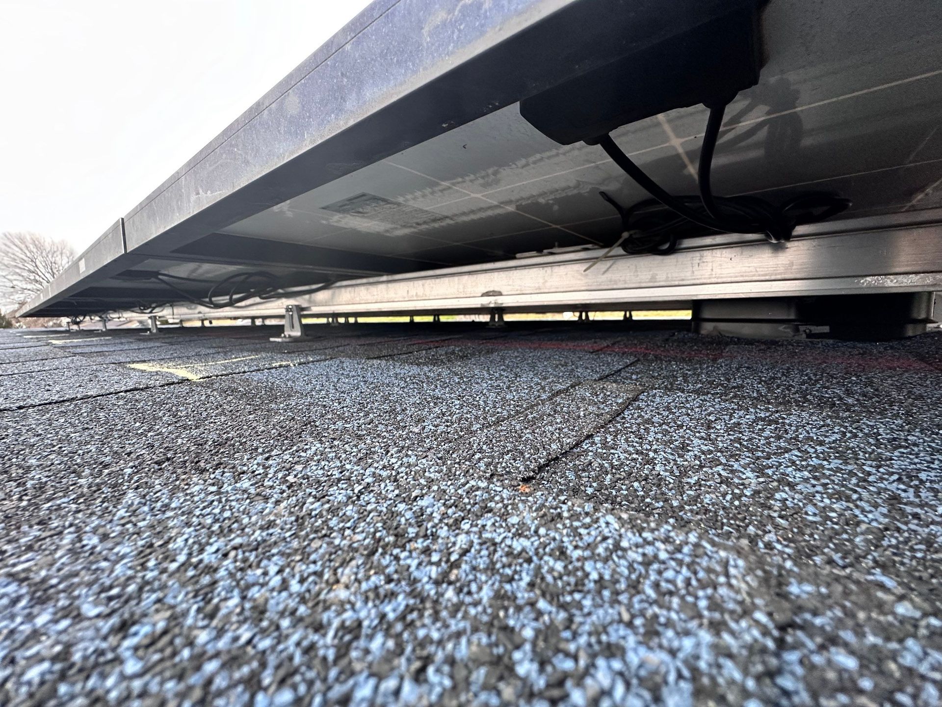 Solar panel array installed on a flat, gravel-covered roof.