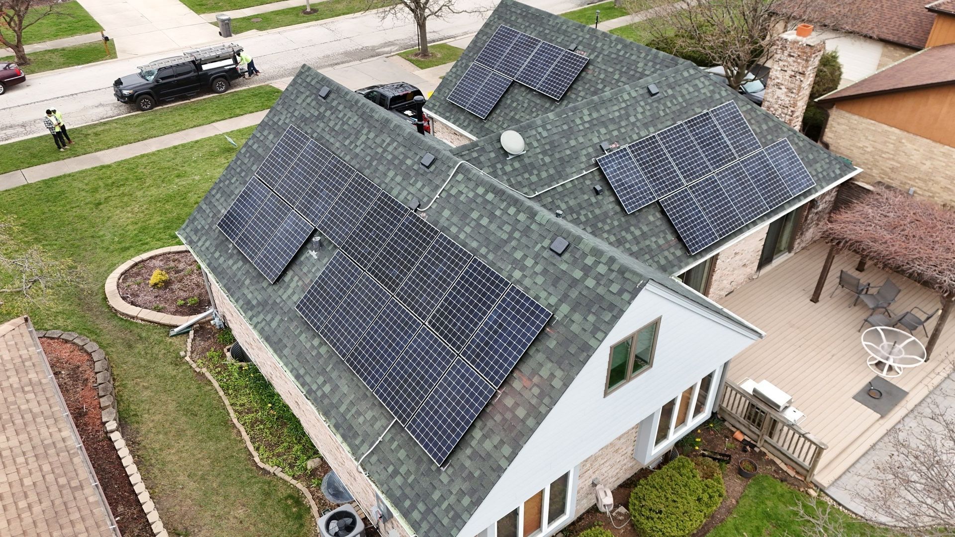 Solar panels installed on a residential rooftop in a suburban neighborhood.