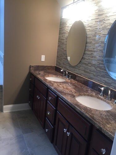 Bathroom Remodeling Contractor — Bathroom With Wooden Cabinet in Lewisville, TX