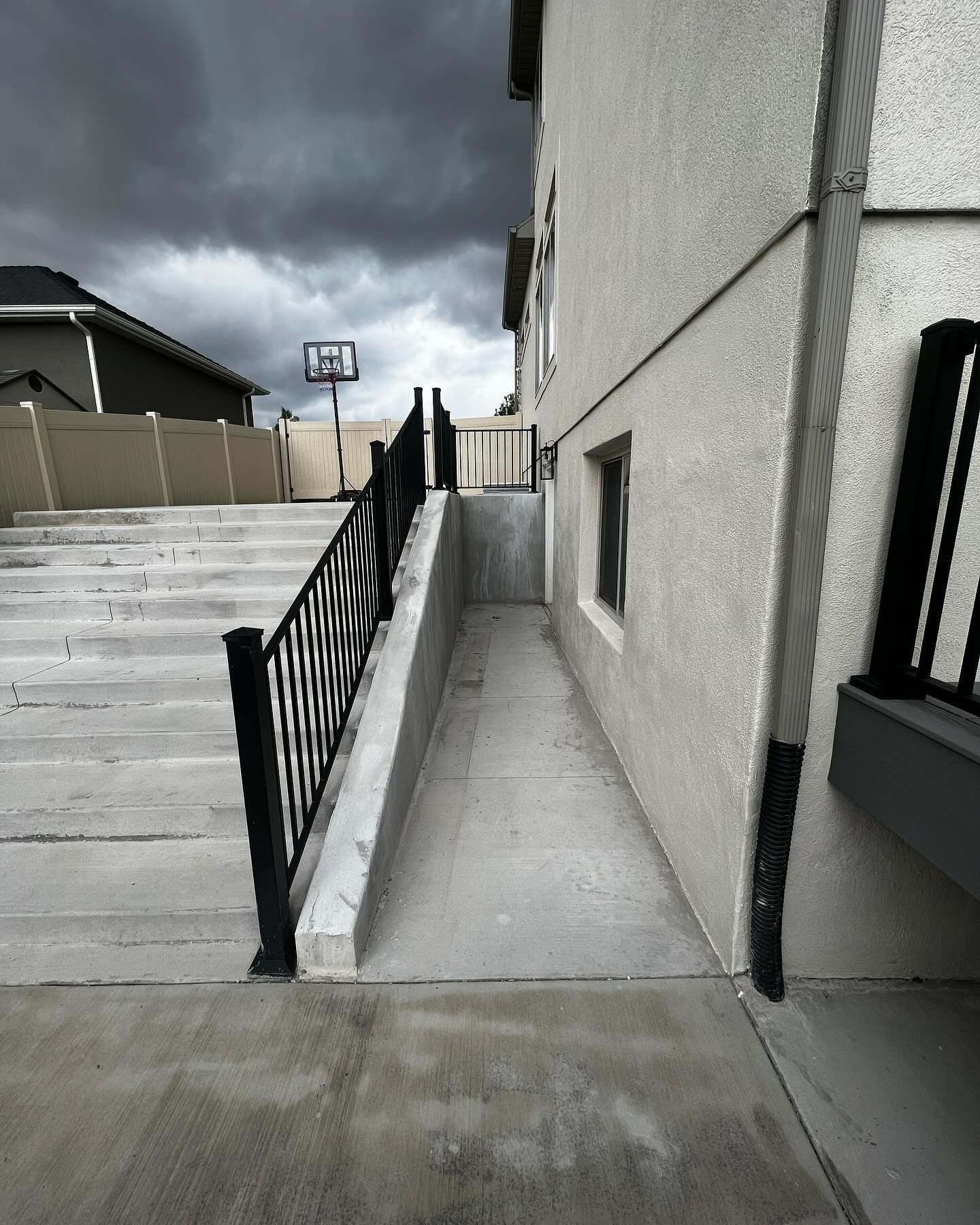 A ramp leading to a house with stairs leading up to it