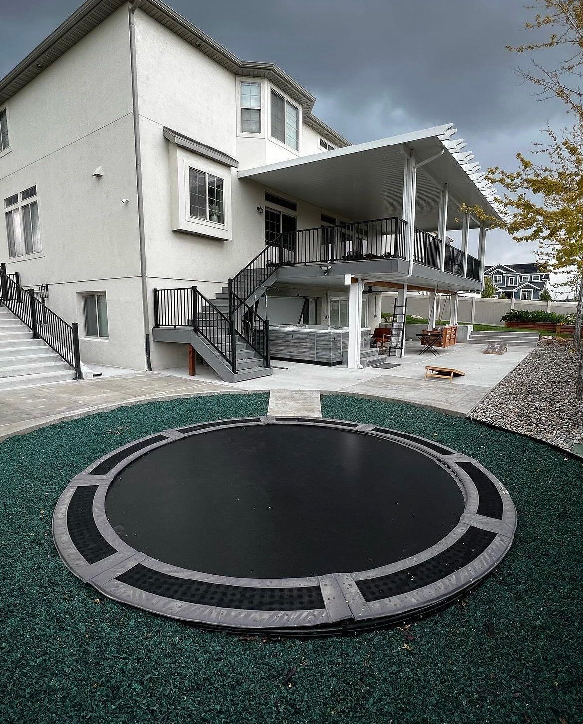 A large house with a trampoline in front of it