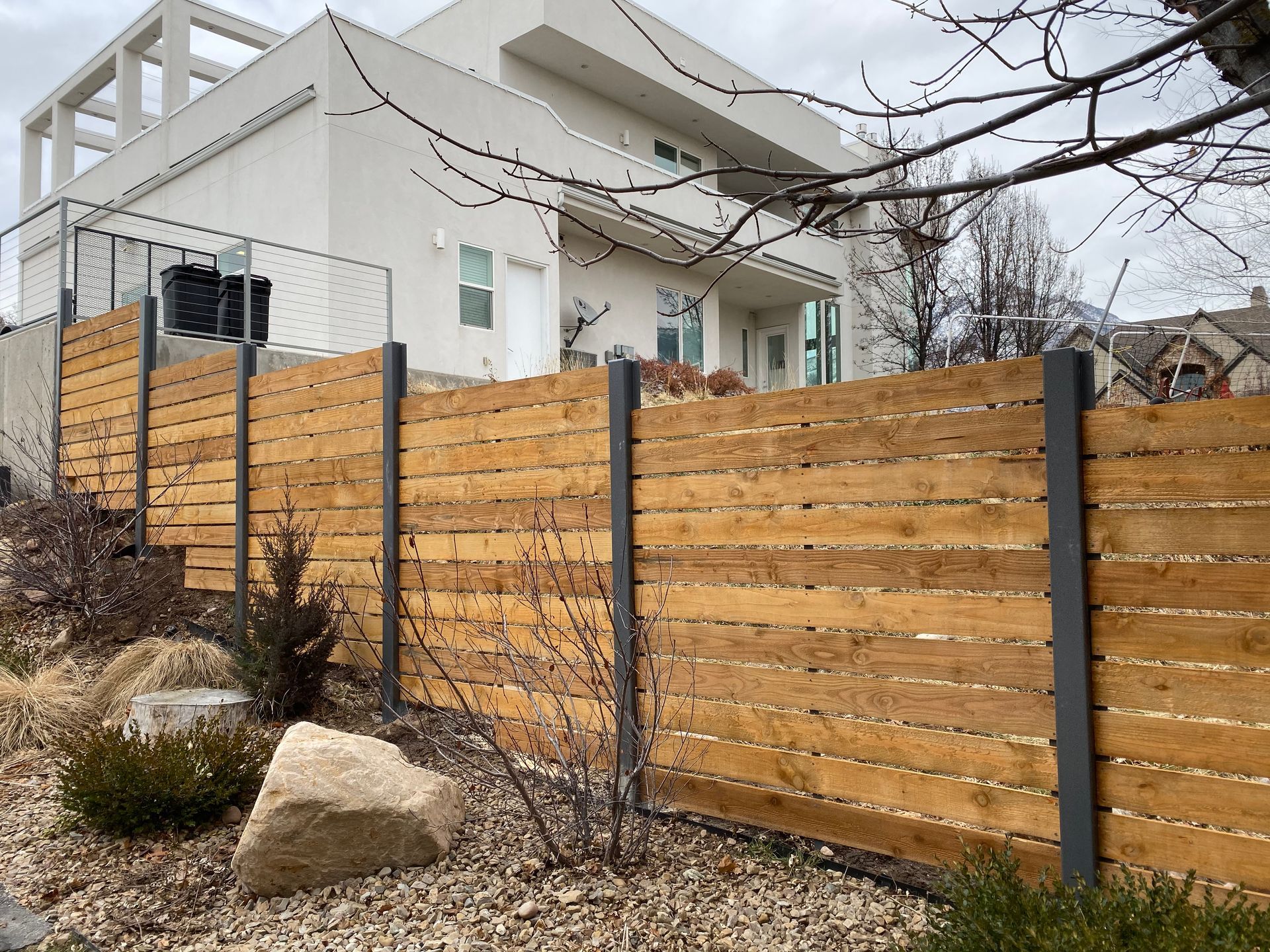 A white truck is parked in a driveway next to a building.
