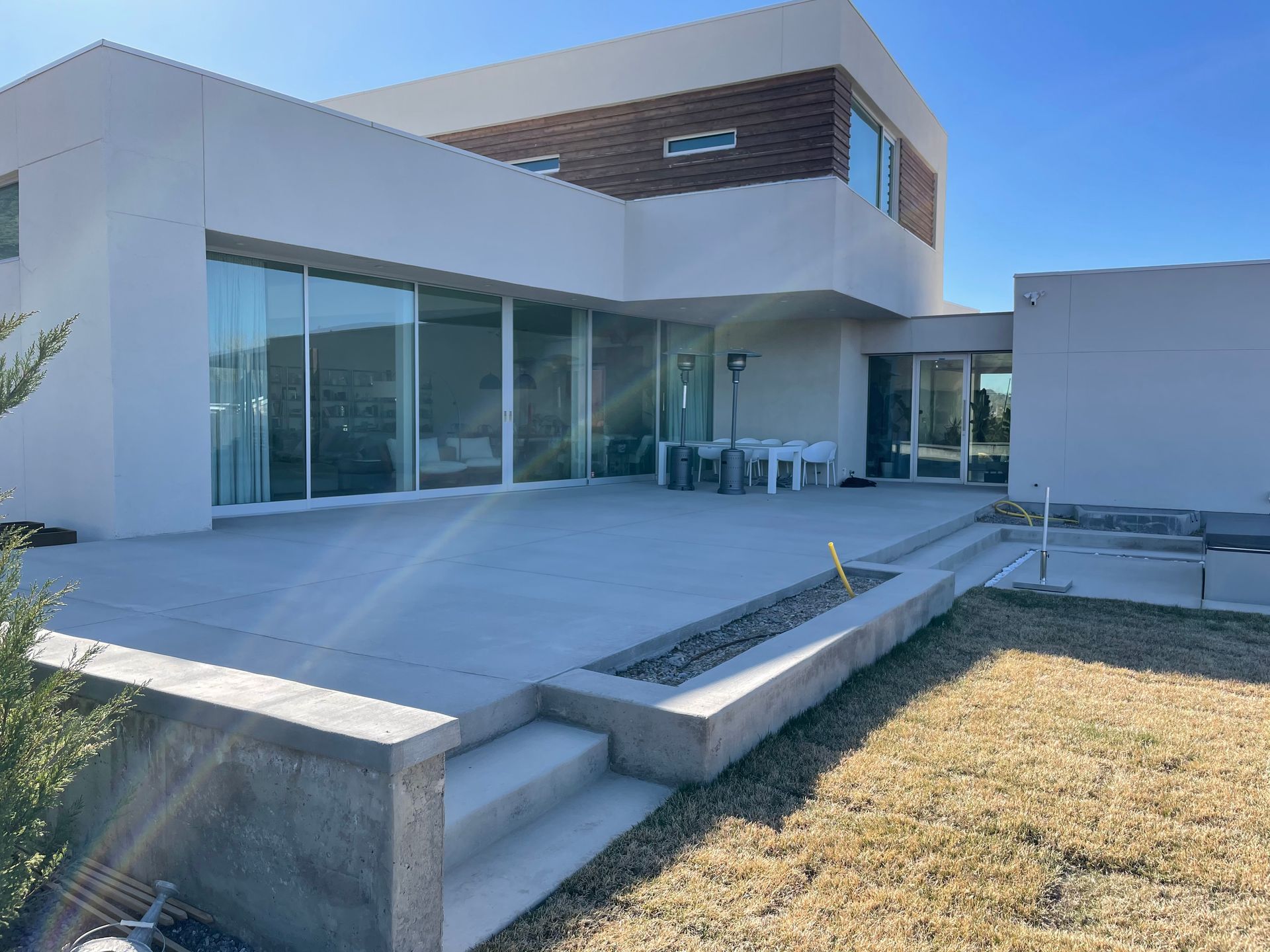 A brick house with a lush green garden in front of it.