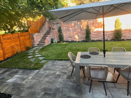 There is a fire pit in the middle of the backyard.