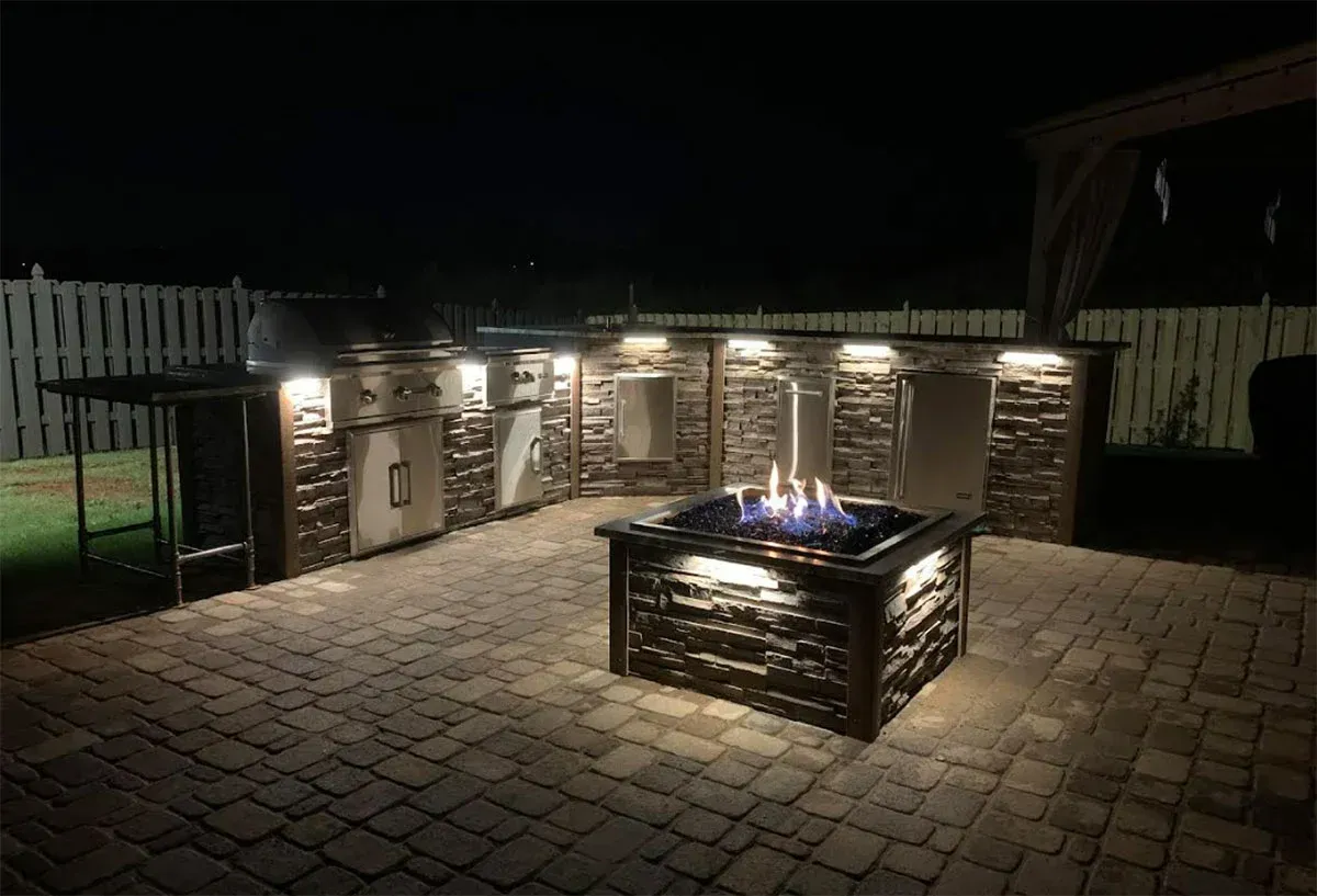 A backyard with a lush green lawn and a pergola.