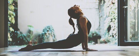 Internal Medicine — Woman Practicing Yoga Indoor in Irvine, CA
