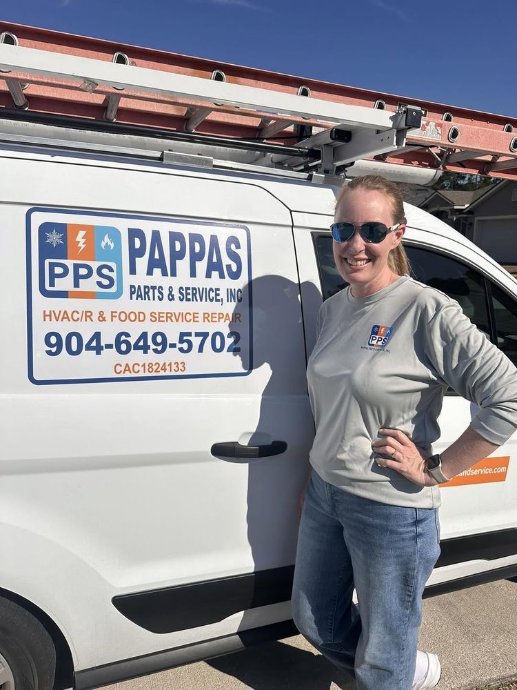 Woman standing beside a white service van with a Papps HVAC logo and ladder on top