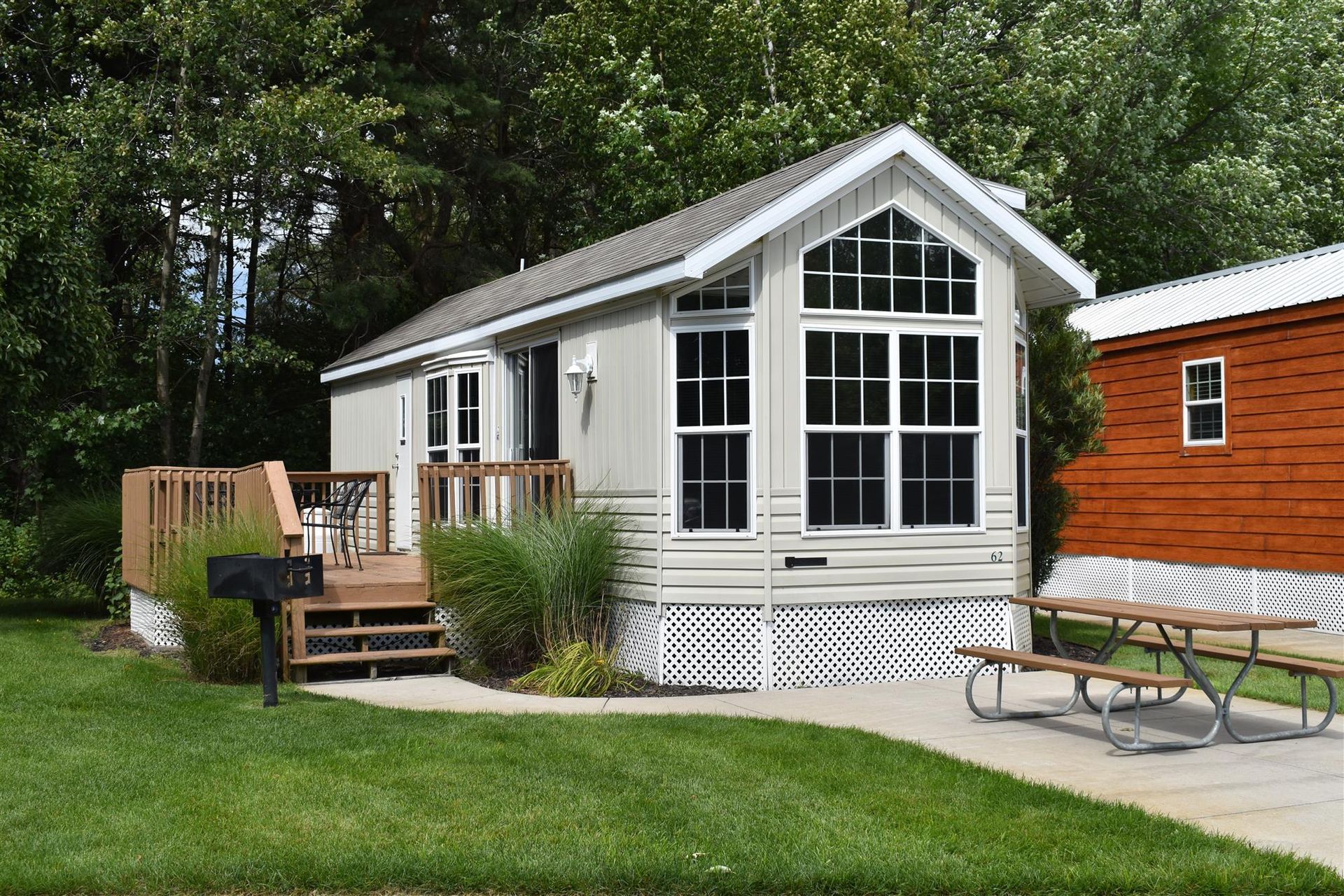 A mobile home with a picnic table in front of it