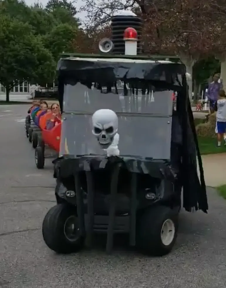 A golf cart with a skull on the windshield
