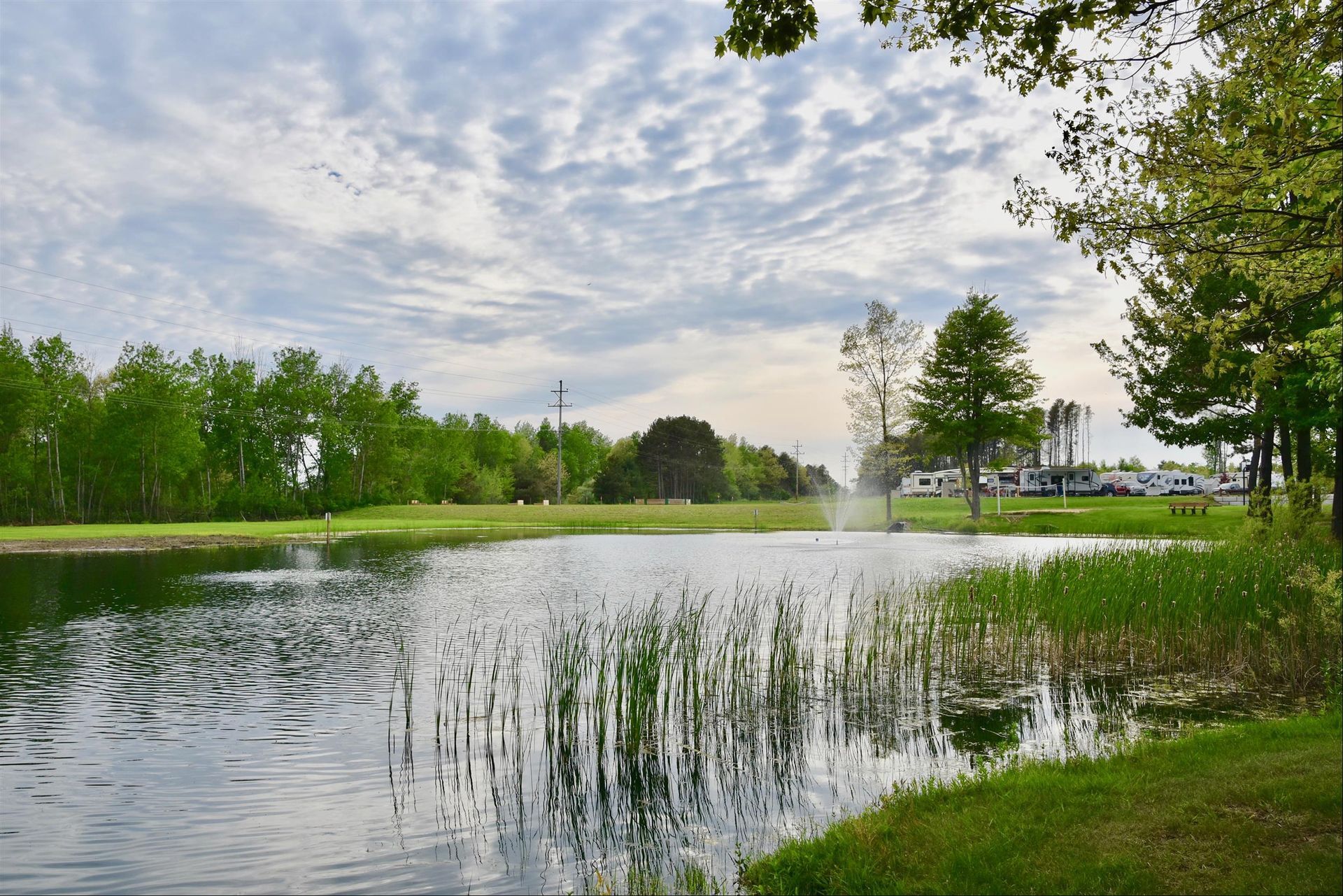 A pond with a fountain in the middle of it