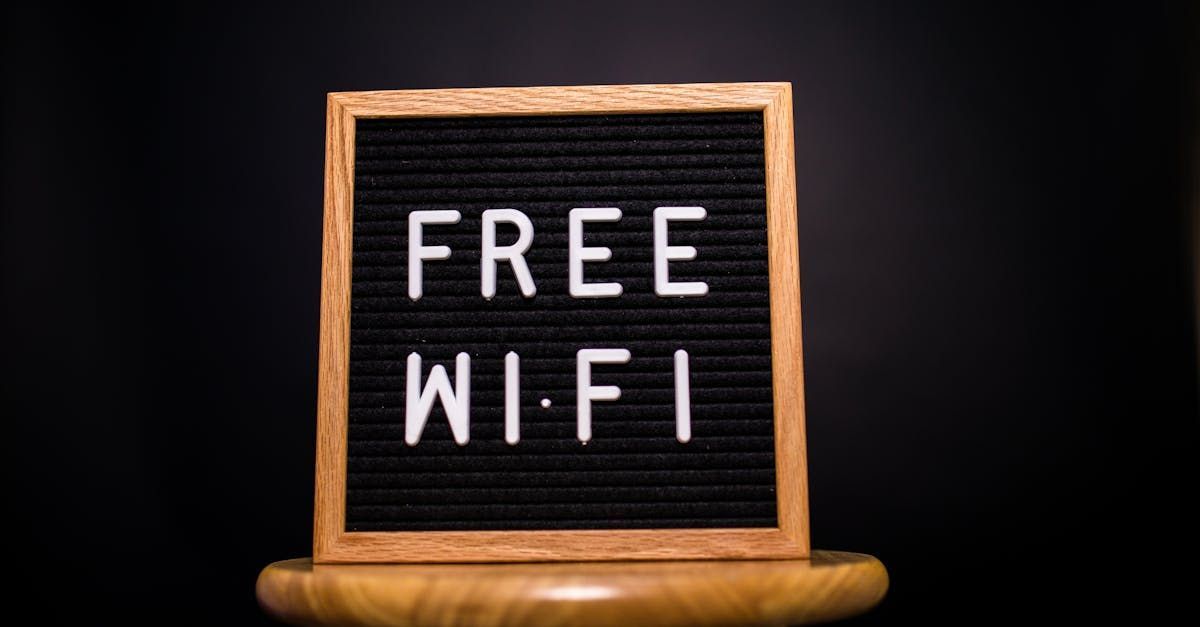 A sign that says `` free wi-fi '' is sitting on a wooden stool.