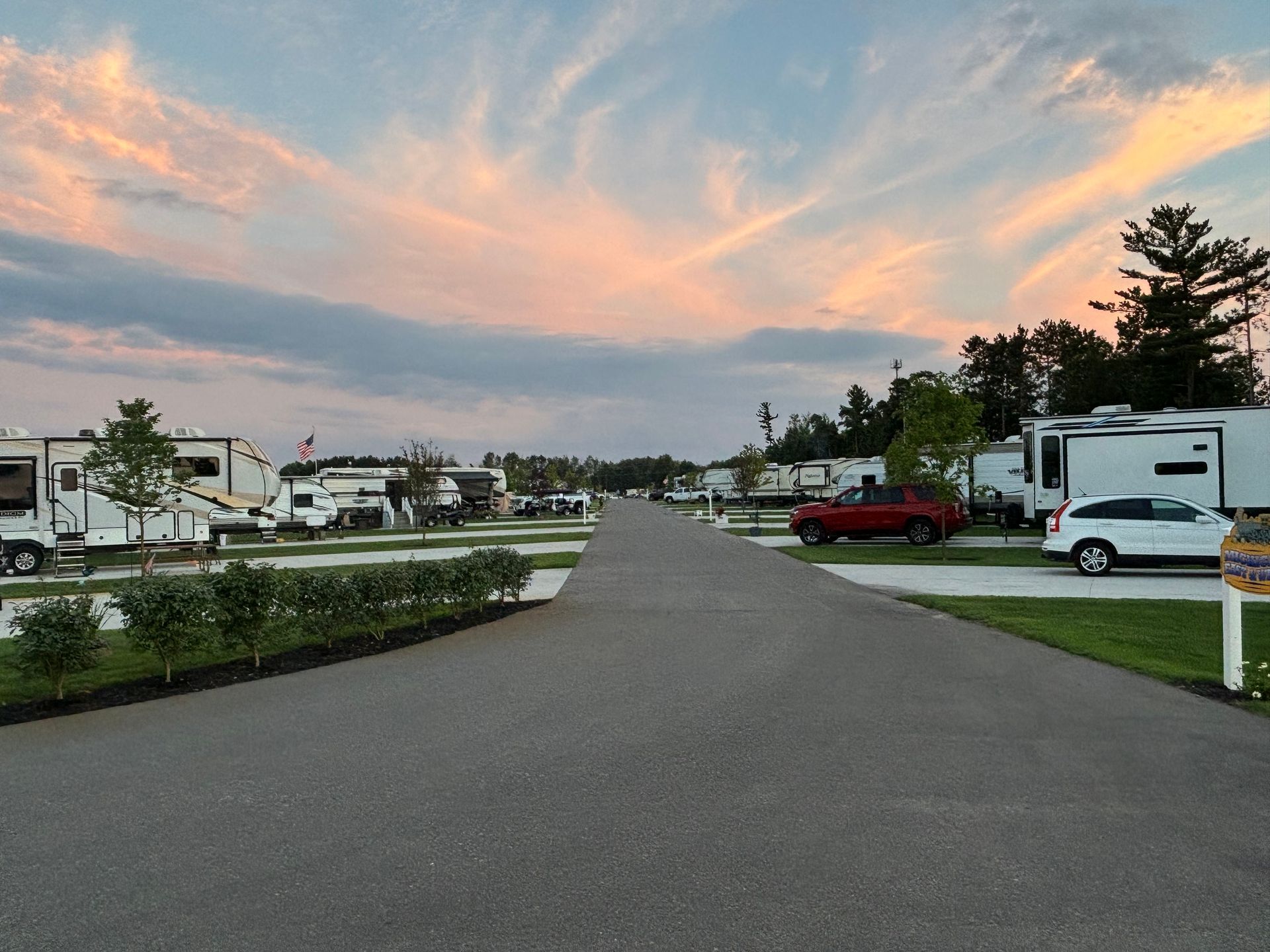 A row of rv 's are parked on the side of a road.
