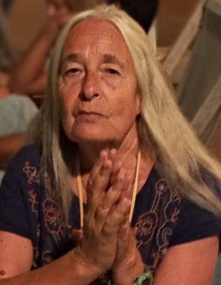 Spiritual Woman praying,  Woman with white hair holding her hands together in prayer.