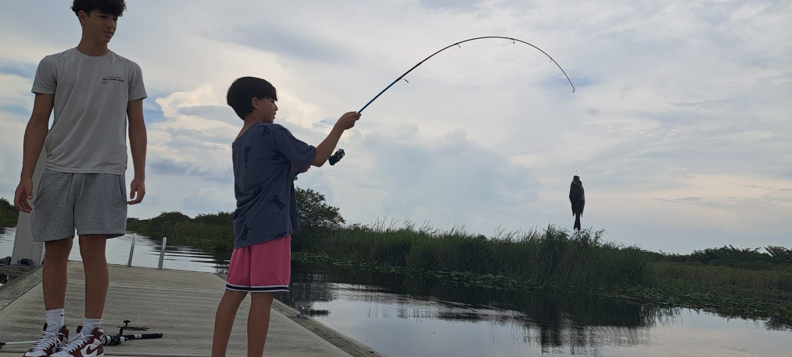 2 boys catching a fish