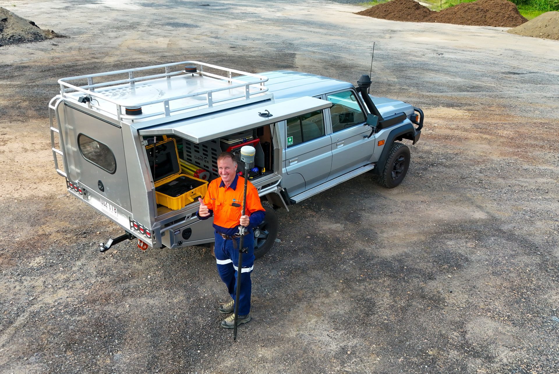 A Theodolite Is Sitting On A Tripod In A Field — TerraModus Surveying In Bayview Heights, QLD
