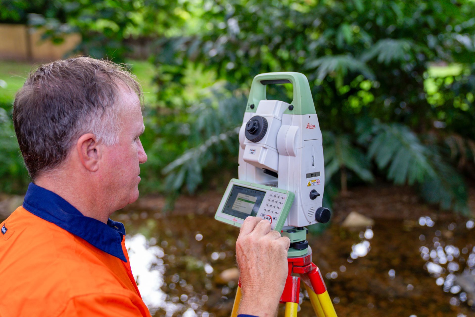 A Couple Of People Are Looking At A Drawing On A Piece Of Paper — TerraModus Surveying In Cape York, QLD