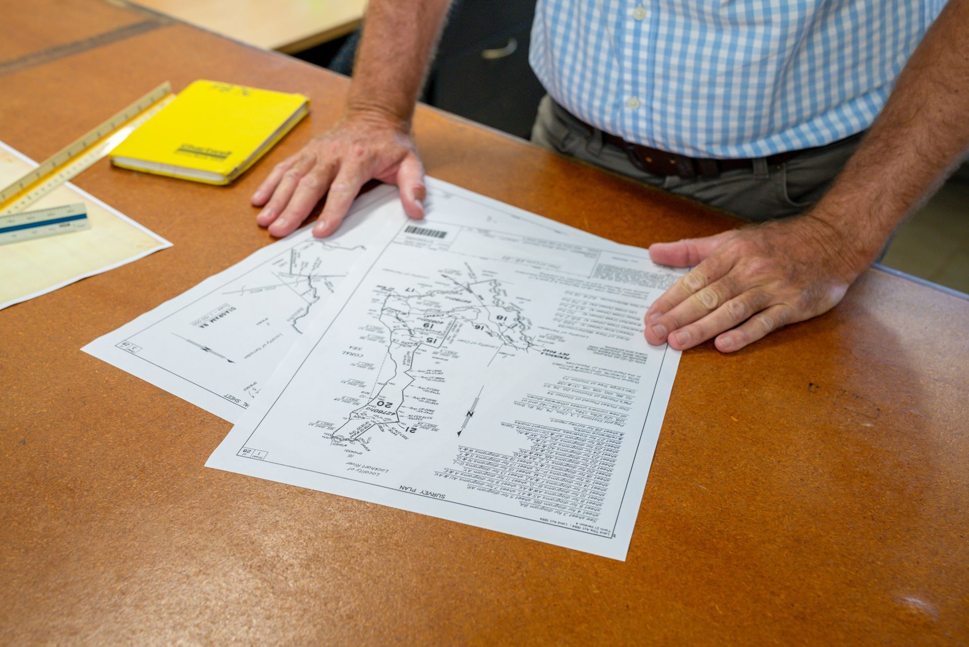 A Yellow Tripod Is Sitting In The Middle Of A Grassy Field — TerraModus Surveying In Douglas Shire, QLD