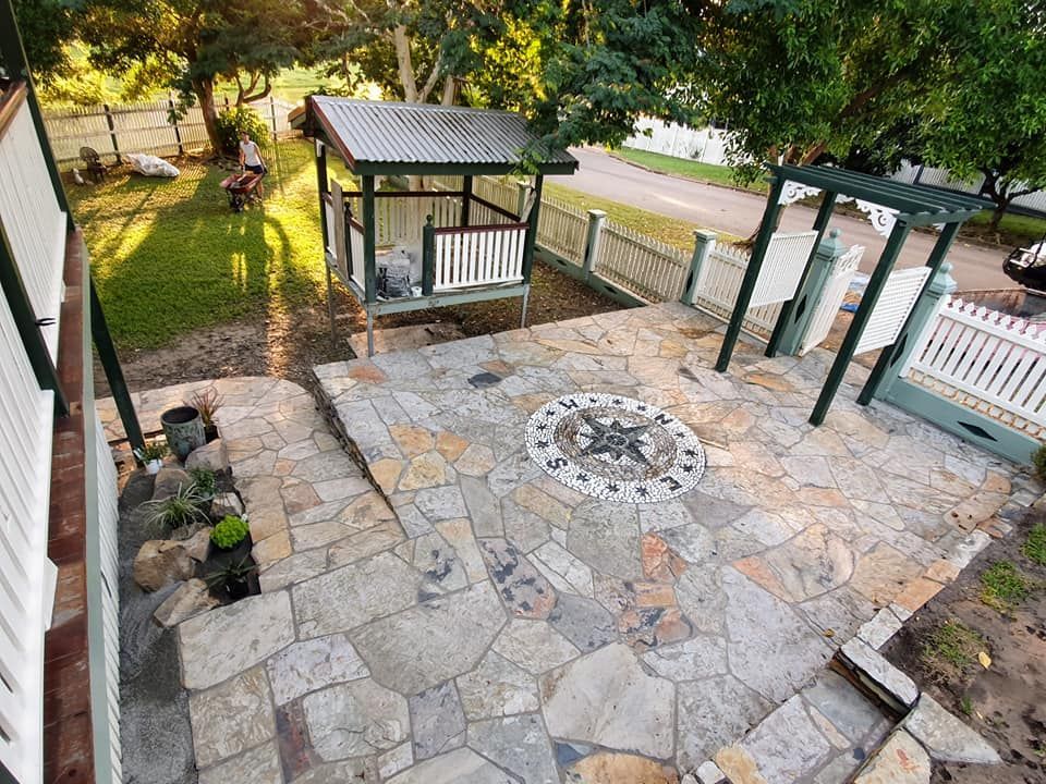 A Stone Patio With a Compass Inlay — High End Stone Masons in West End, QLD 
