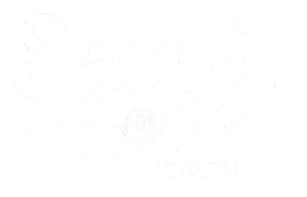 White logo for Sacred Heart Health featuring stylized text and a heart-shaped emblem.