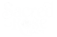 White logo for Sacred Heart Health featuring stylized text and a heart-shaped emblem.