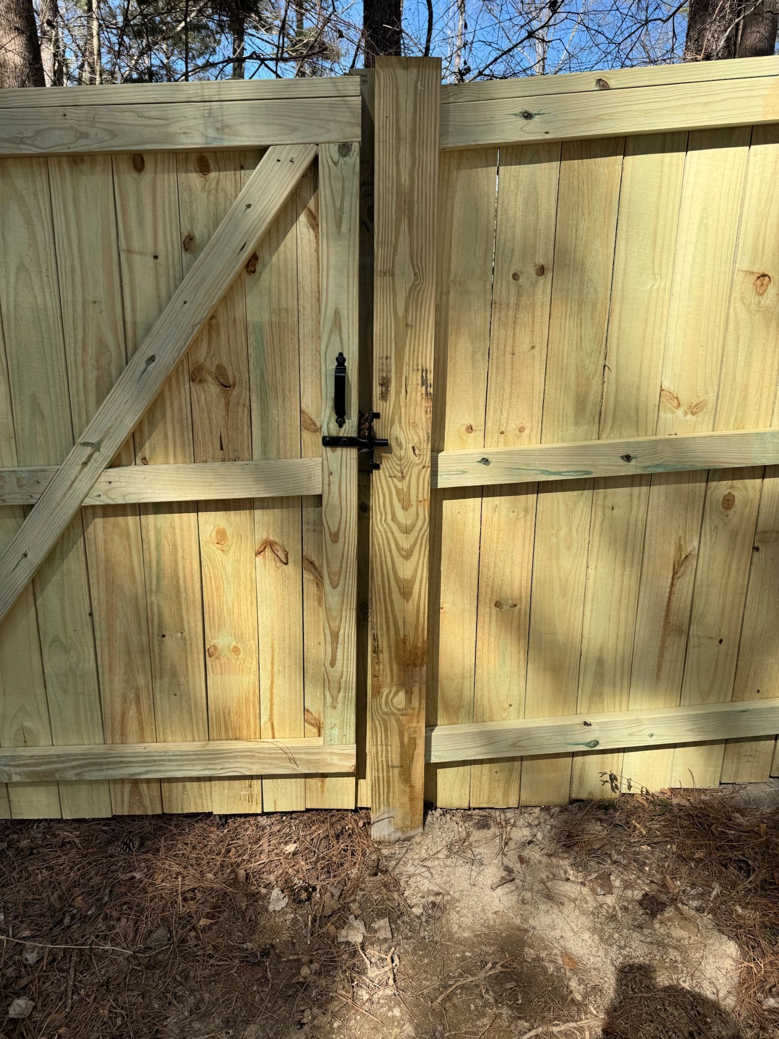 A wooden fence with a gate attached to it.