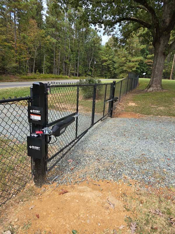 A wooden fence with a gate in front of a house.