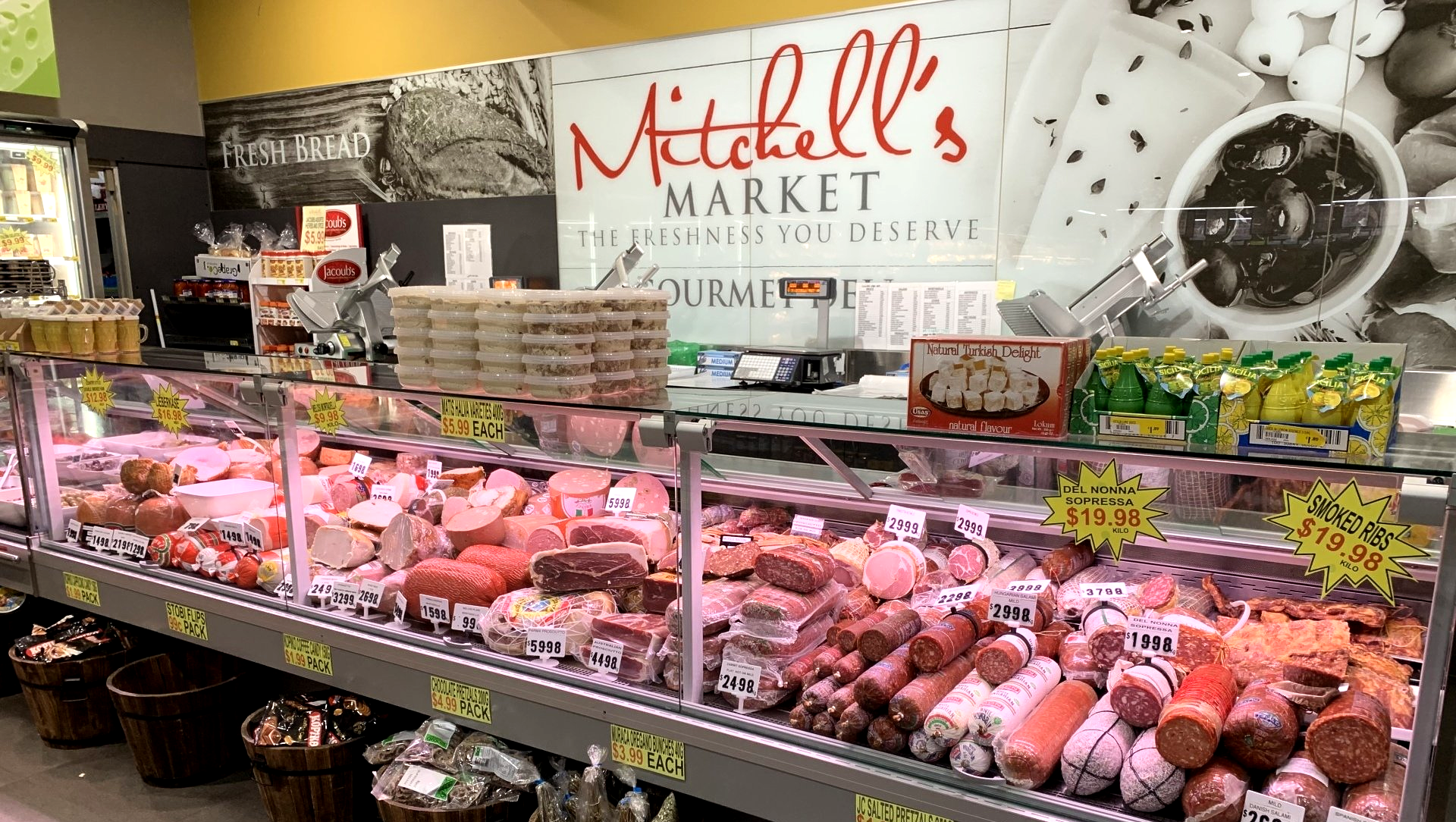 a grocery store filled with lots of meats and vegetables .