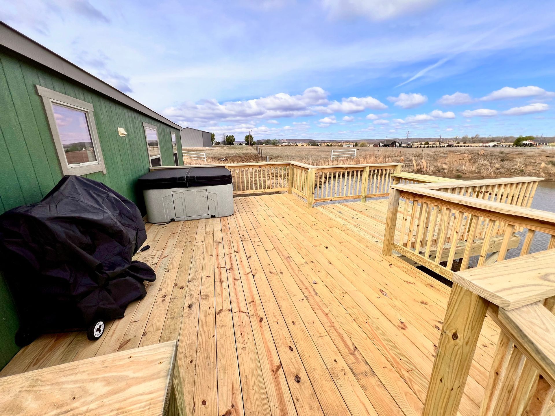 Person planting bushes in a garden bed with a brick retaining wall.