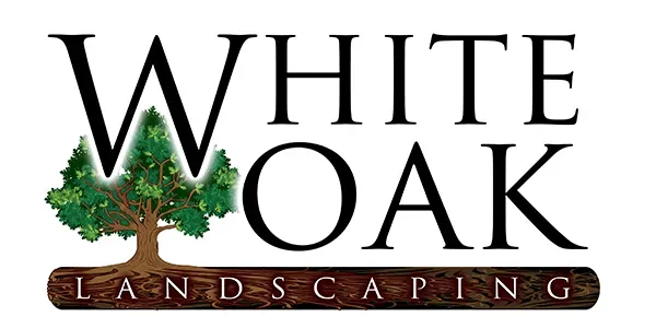 Logo for White Oak Landscaping featuring a tree graphic and text on a wooden texture.