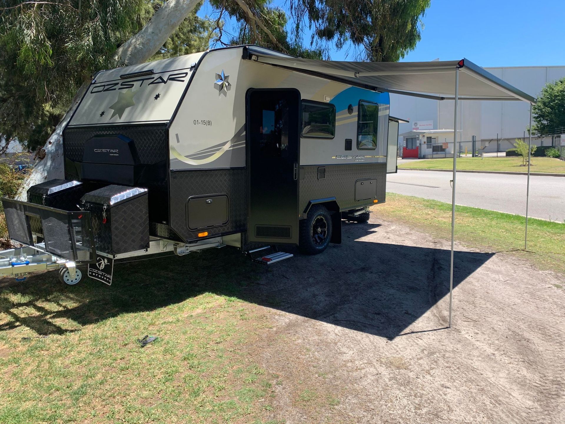 Oz Star Koala with a canopy is parked in a grassy area