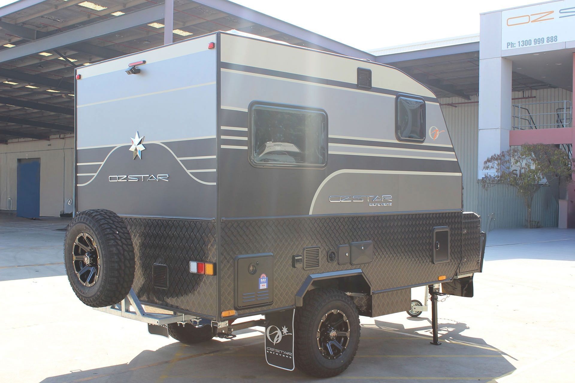 Oz Star Dingo parked in a parking lot in front of a building.