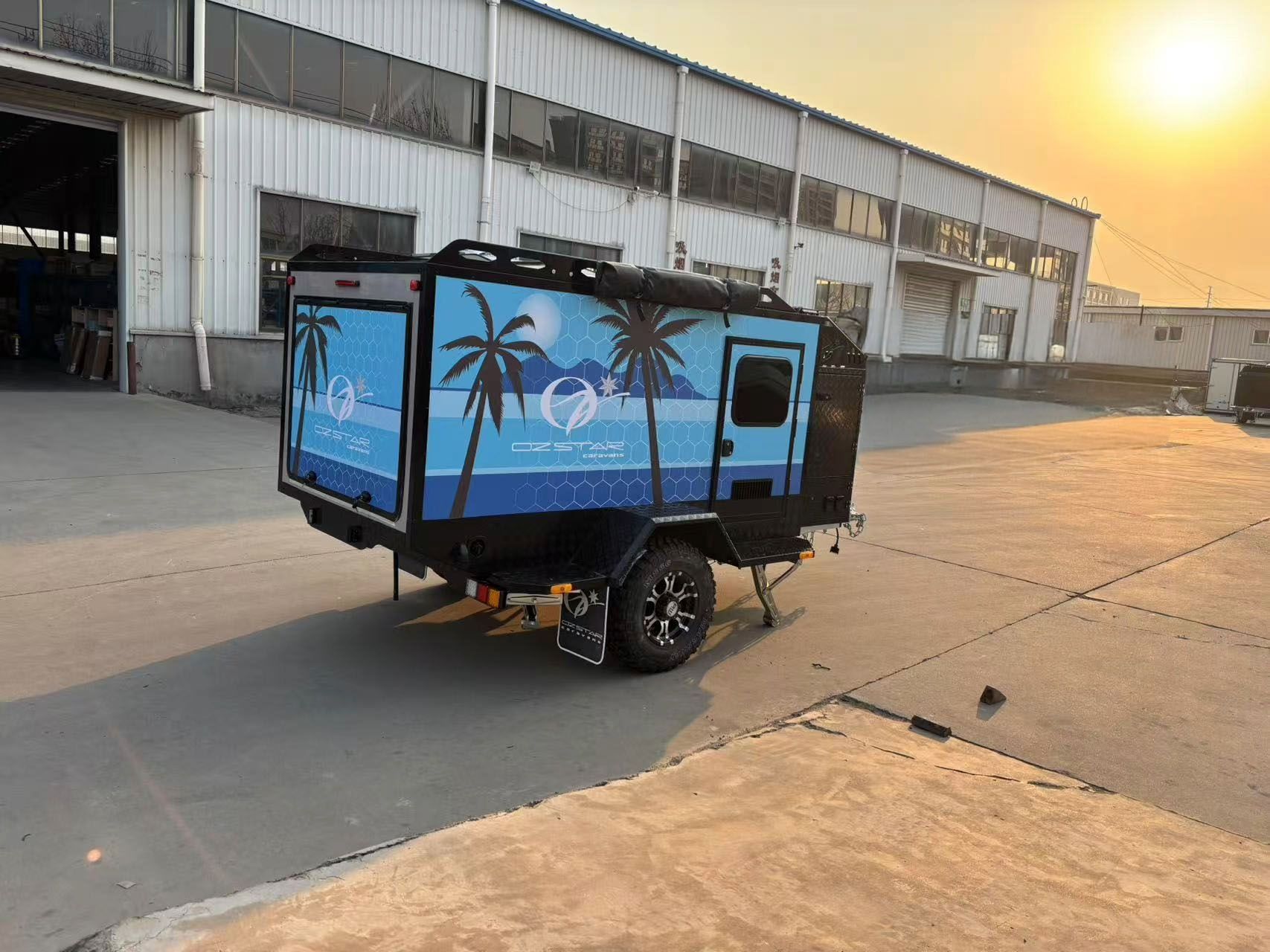A 7-foot trailer caravan is parked in a parking lot in front of a building.