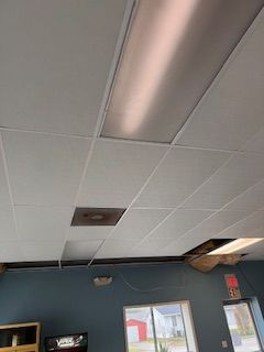 A room with a ceiling that has a hole in it.