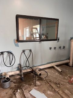 A room with a large window and a chair in it.