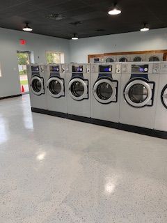 A row of washing machines in a laundromat.