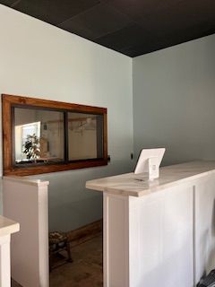 A white counter in a room with a large window.