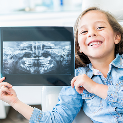 Little Girl Holding Teeth X-ray — Newton, SA — Arena Dental