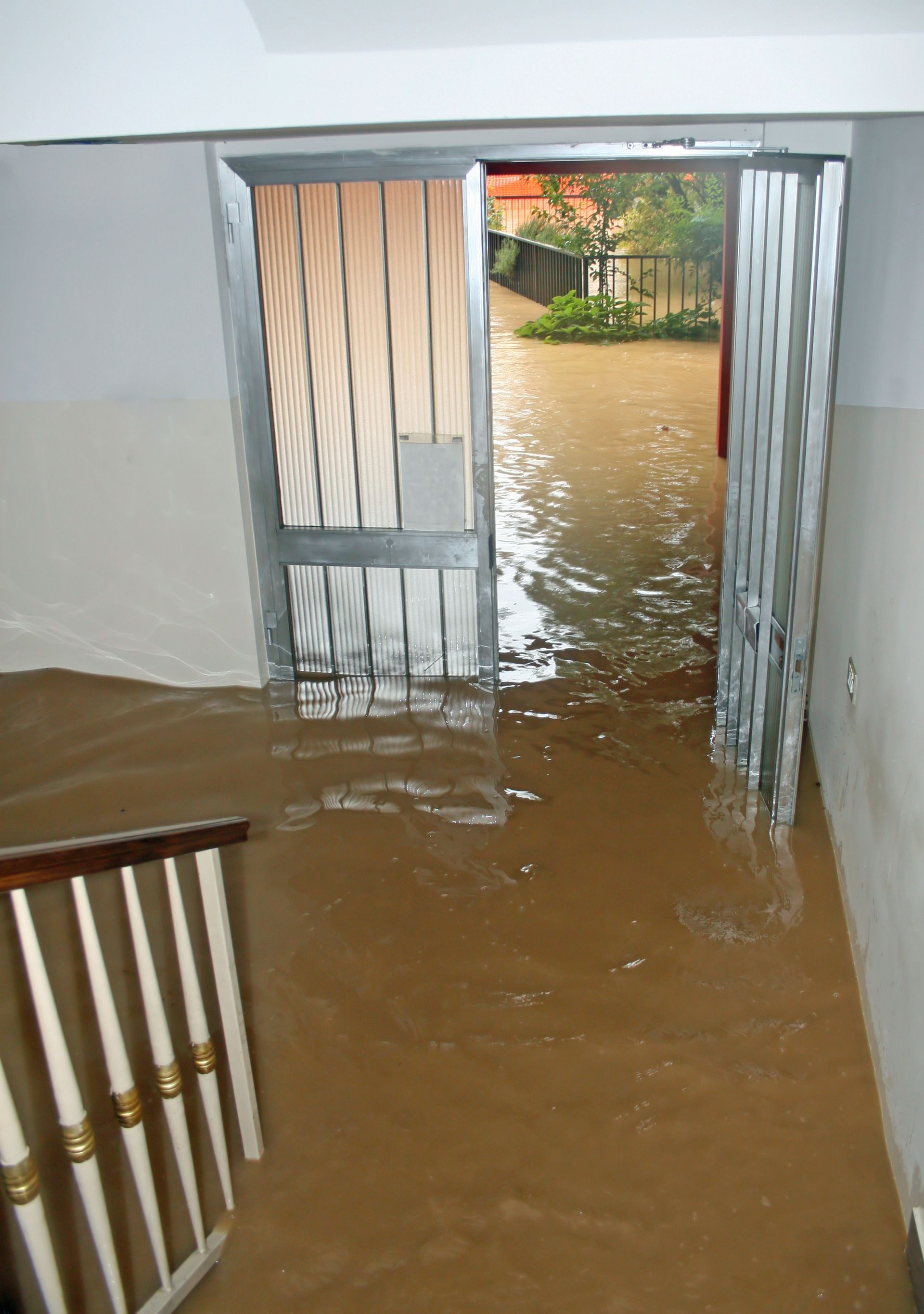 Severe flooding damages a home entryway, requiring expert flood repairs in St. Petersburg, FL, by Co