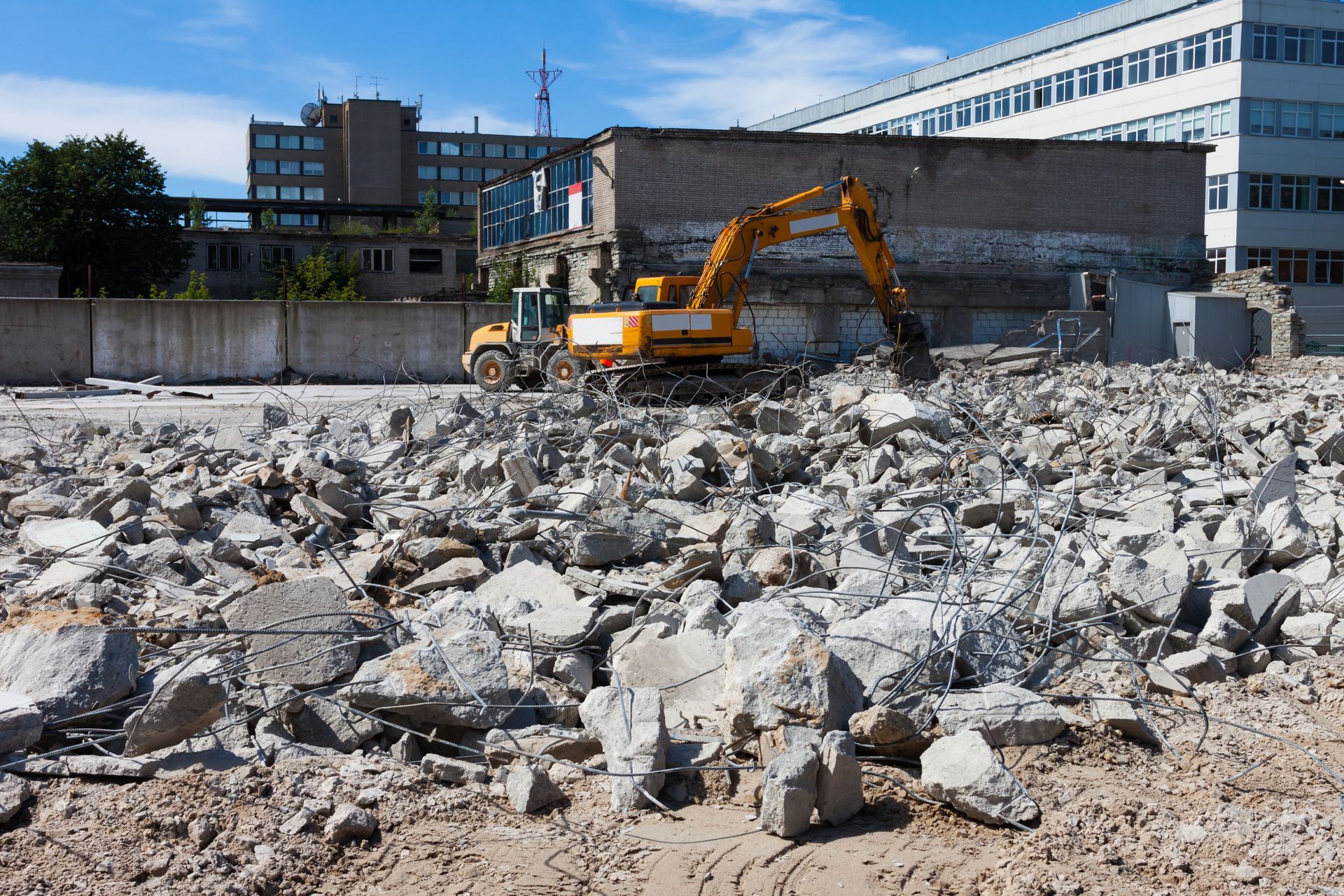 A digger demolishing houses for reconstruction.